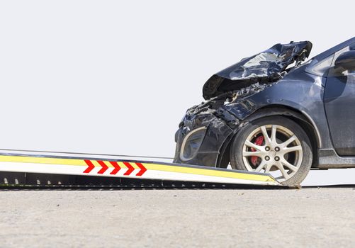 accident Car Slide on  truck for move. Black car have damage by accident on road take with slide truck move . Isolate on white background.