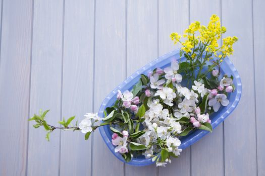 Festive flower composition frame on the blue planks wooden background. Overhead view.