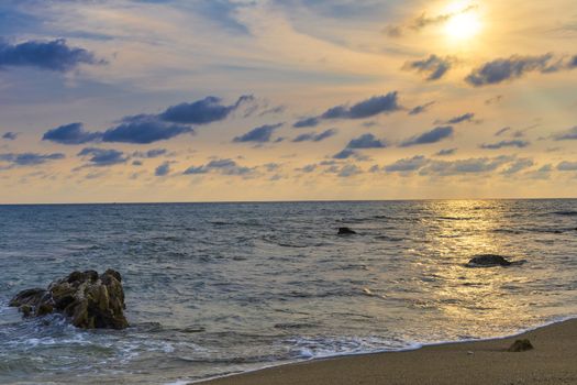 Soft wave from sea come to wet sand beach with blur clear sky and sun ray background. With copy space for text or design. Beach background.