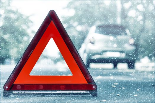 Snow time black car have accident park on road. Red triangle, red emergency stop sign, red emergency symbol and black car stop and park on road.