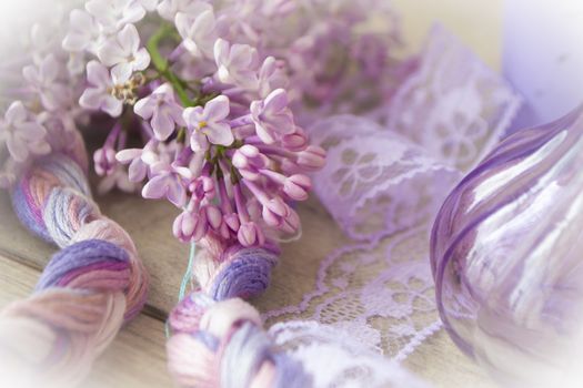 Happy mothers day or wedding concept. Lilac flowers, violet glass and ribbon. Stylish floral greeting card