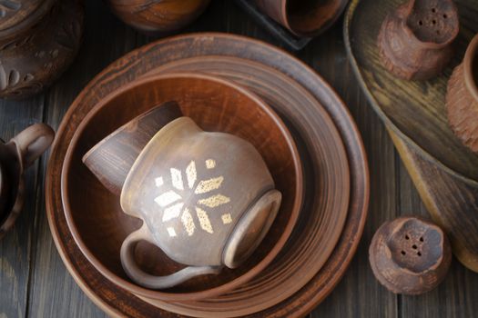 Rustic handmade ceramic clay brown terracotta cups, plates, bowls. Flat lay