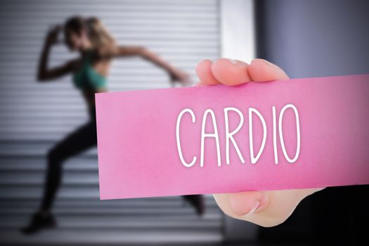 The word cardio and young woman holding blank card against 