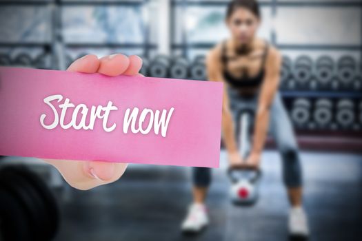 The word start now and young woman holding blank card against 