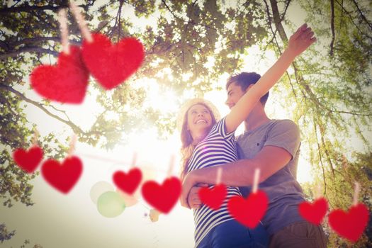 Loving couple against hearts hanging on a line