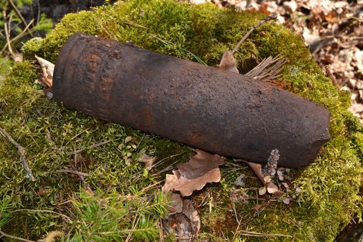 Concept of danger: close up of old whizbang, artillery rusty whizzbang high explosive of the Second World War in thicket forest of Belarus