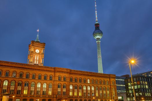 The red city hall and the famous Television Tower in Berlin at night