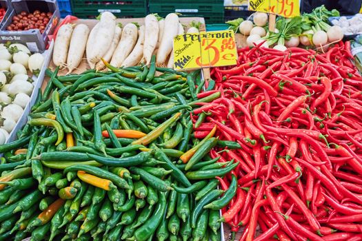 Green and red chilies for sale at a market