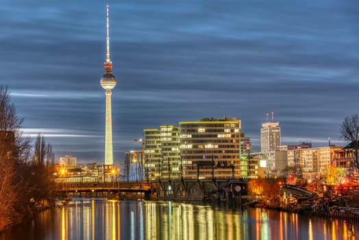 The river Spree, the famous Television Tower and some office buildings in Berlin at night