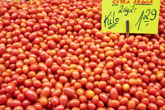 Pile of small tomatoes for sale at a market