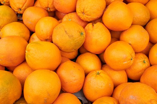Pile of ripe oranges for sale at a market