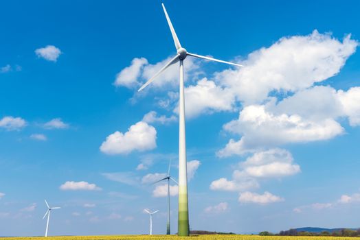 Wind turbines and flowering oilseed rape seen in Germany