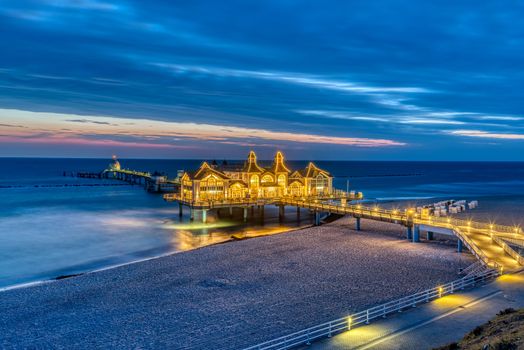 Beach and sea pier in Sellin on Ruegen island in Germany before sunrise