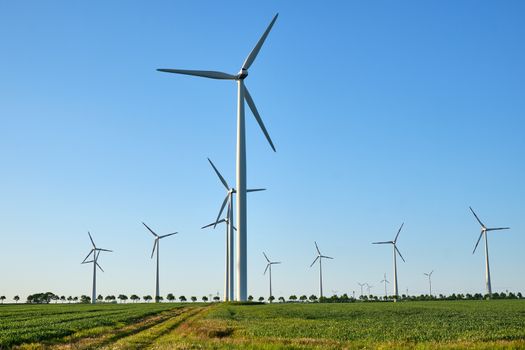 Wind turbines against the light seen in rural Germany