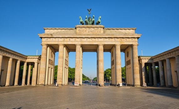 The famous Brandenburg Gate in Berlin in front of a clear blue sky