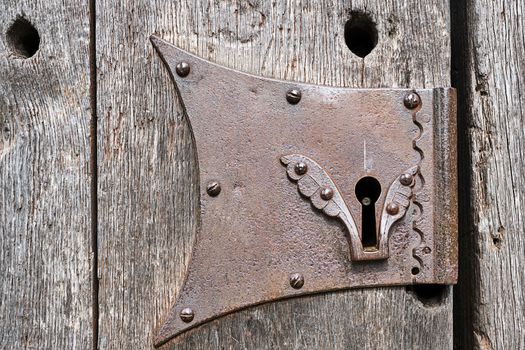 Detail of a keyhole of an old wooden door