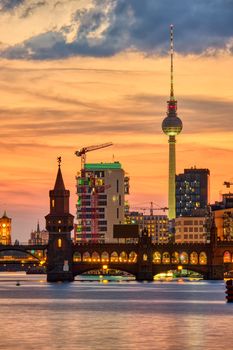 Dramatic sunset at the Oberbaum Bridge and the famous Television Tower in Berlin