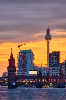 Dramatic sunset at the Oberbaum Bridge and the famous Television Tower in Berlin