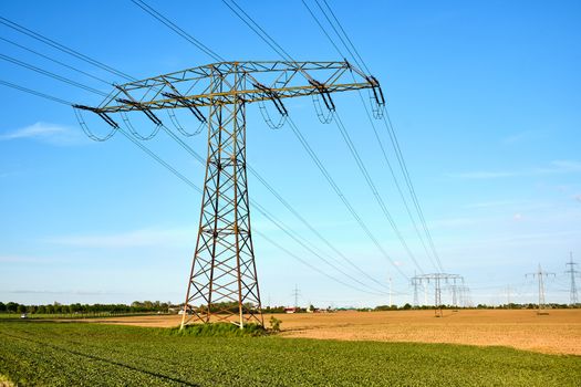 High-voltage power lines on a sunny day seen in Germany