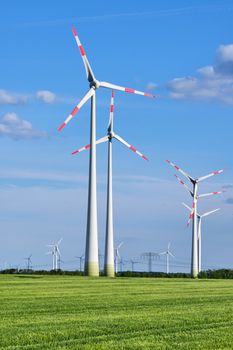 Wind turbines in a green corn field seen in Germany