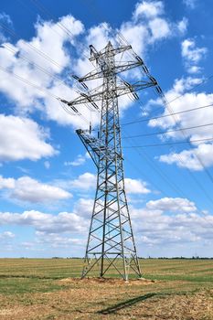 An electricity pylon with medium voltage power lines seen in Germany