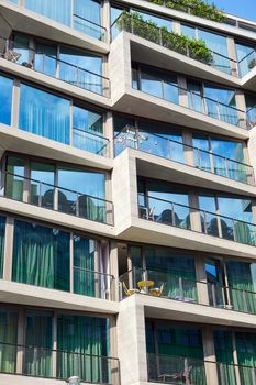 Detail of an apartment building with floor-to-ceiling windows seen in Berlin, Germany