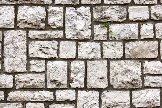 Background from a wall made of block shaped old natural stones