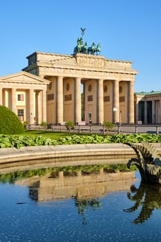 The famous Brandenburger Tor in Berlin with reflections in a fountain