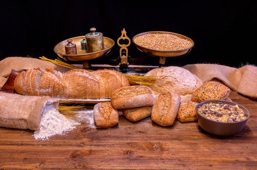 Bread and flour on a rustic wooden table. Bakery and grocery food store concept.