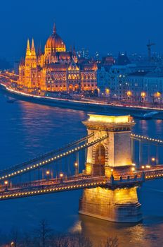 Budapest city night scene. View at Chain bridge, river Danube and famous building of Parliament. Budapest city is capital of Hungary.