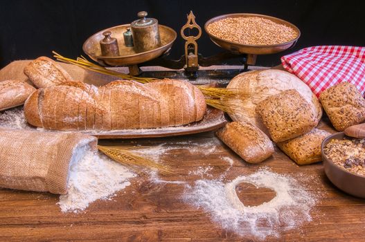 Bread and flour on a rustic wooden table. Bakery and grocery food store concept.