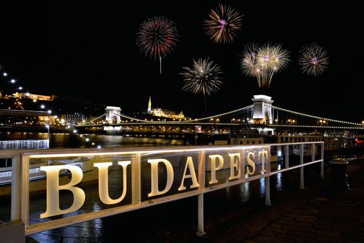 Szechenyi Chain bridge over Danube river with fireworks on Budapest city, Hungary.