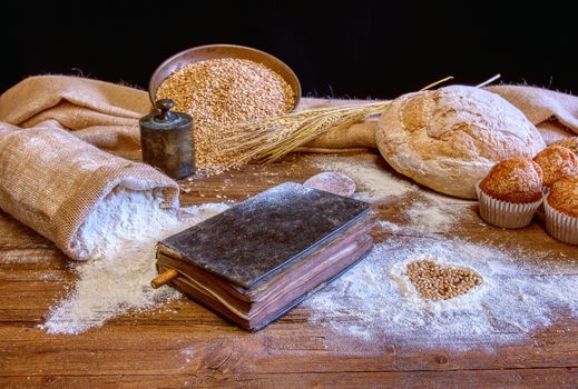 Bread and flour on a rustic wooden table. Bakery and grocery food store concept.