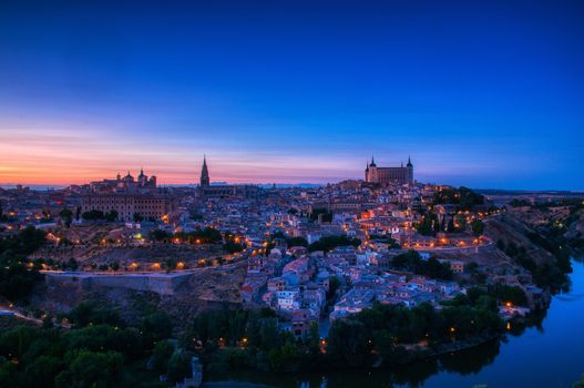 Panoramic view of the medieval center of the city of Toledo, Spain. It features the Cathedral and Alcazar of Toledo, Spain.