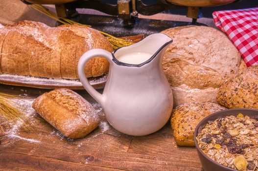 Bread and milk on a rustic wooden table. Bakery and grocery food store concept.