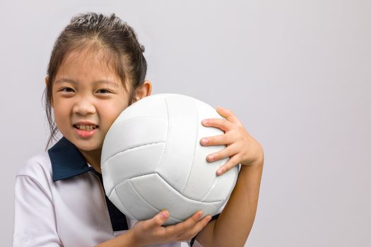 Child holding ball, studio shot, isolated on white.
