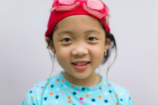 Portrait of Asian child in swimming suit.