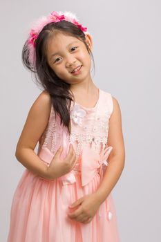 Child in peach princess dress, isolated on white background.