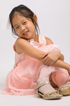 Kid in pink dress, isolated on white background.
