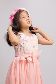 Child in pink dress, isolated on white background.