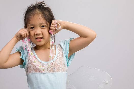 Kid in ballet dress, isolated on white background.
