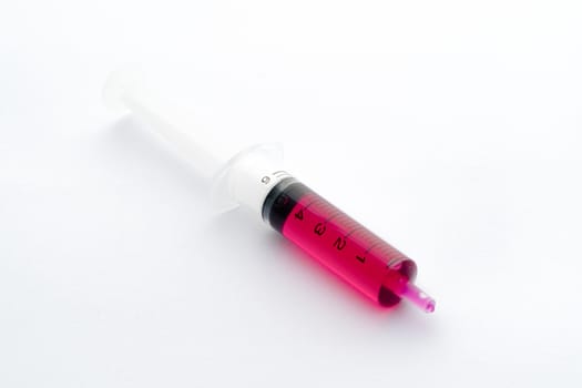 Studio shot of syringe containing liquid medicine for kid isolated on white background.