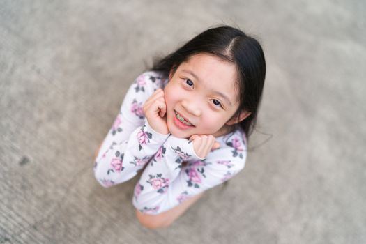 Braces on teeth of young Asian child.