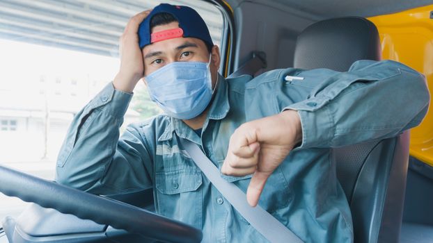 Photos of Asian truck drivers wearing masks to protect against dust and the spread of COVID 19 in front of the car. Safety ideas for a worker in the transportation business. And is a new normal life.