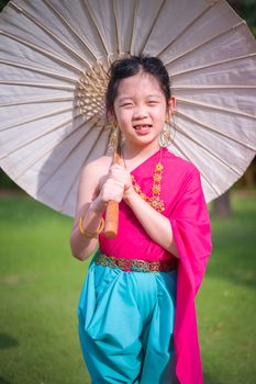 Child, Thai girl, in traditional Thai costume.