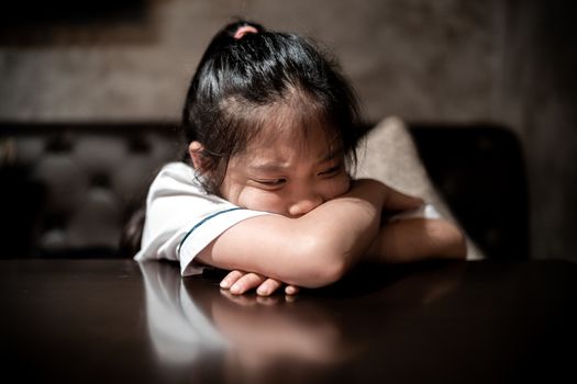 Angry and depressed child with sad and stressful facial expression.