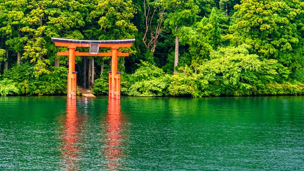 Red Japanese gate or Torii in lake Hakone.