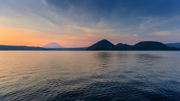 Scene of mountain and lake at twilight in Hokkaido, Japan.