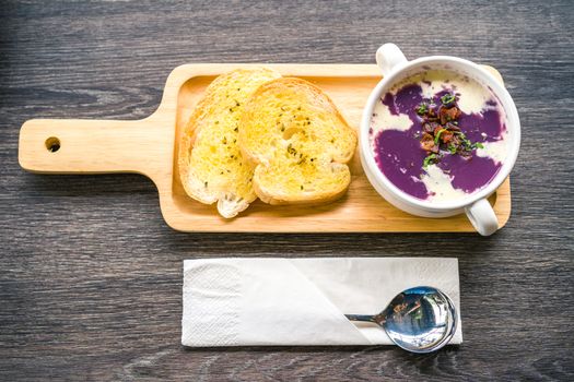 Purple potato soup served with baked bread.