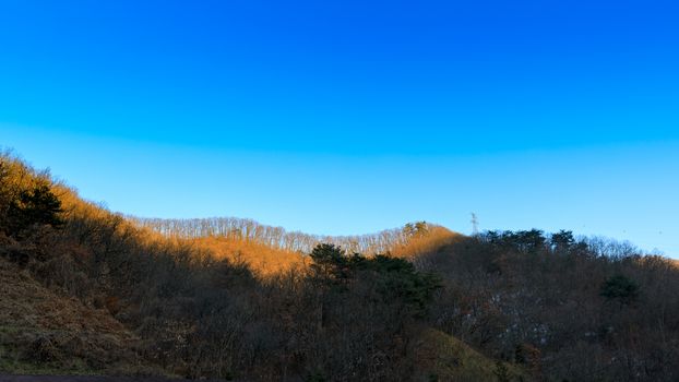 Background of clear blue sky and mountain in evening.